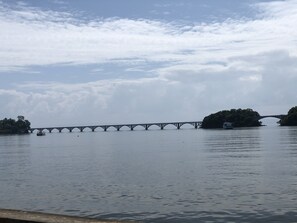 A bridge over a body of water with a boat in the foreground. - Figaro Hotel Boutique (Samaná)
