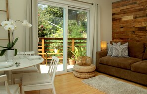 Deluxe One Bedroom Suite | Living area | Flat-screen TV, books