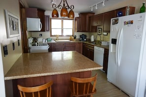 Enjoy cooking in this well-equipped kitchen with a central island and ample storage.