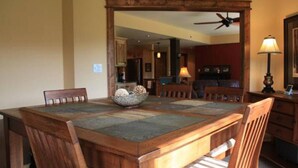A dining area with a wooden table, chairs, and a decorative bowl.