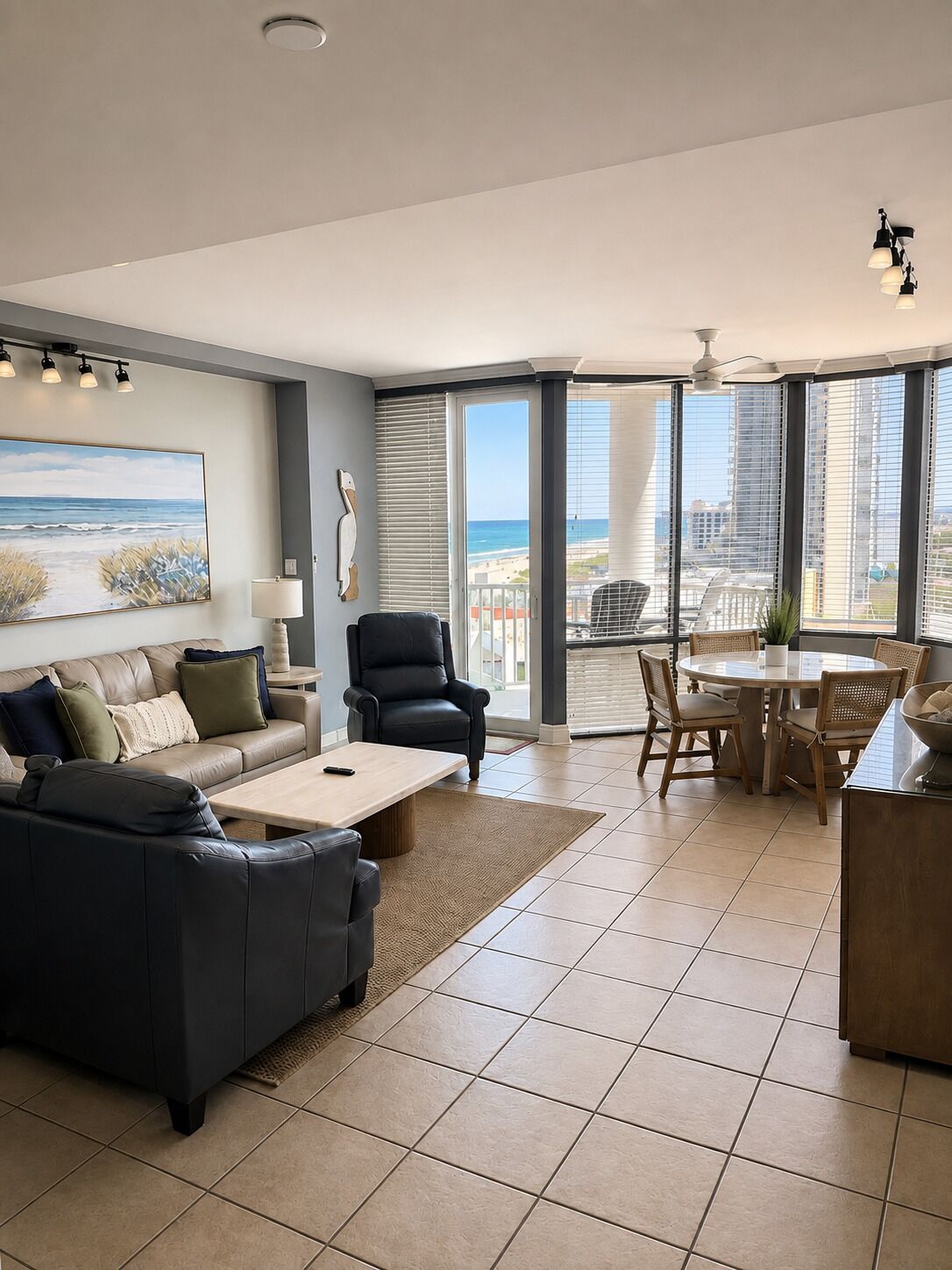 A modern living room with a sofa, coffee table, and dining area.