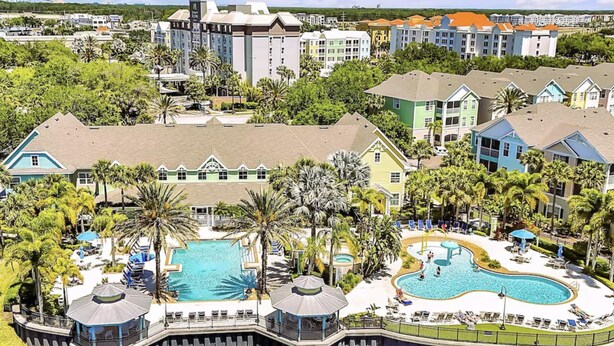 A resort with multiple swimming pools, a dock, and a variety of buildings. - Clean, Comfortable, Family Friendly Condo, EXCELLENT Location! Mins to DISNEY!!  (Kissimmee)