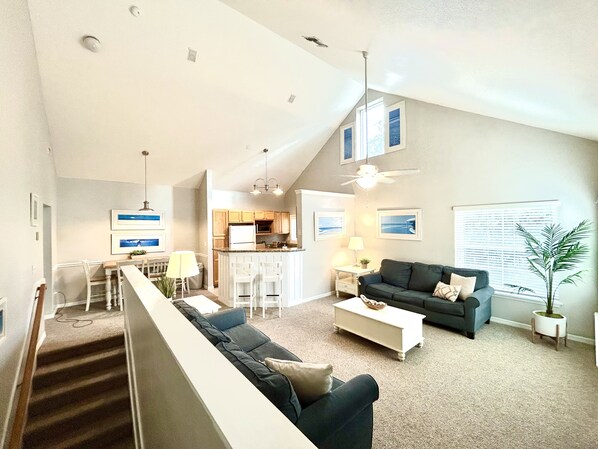 A spacious living area with a high ceiling, a dining area, and a kitchen. - Clean, Comfortable, Family Friendly Condo, EXCELLENT Location! Mins to DISNEY!!  (Kissimmee)
