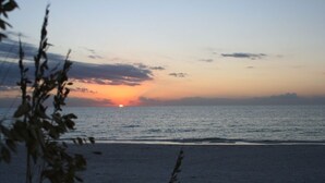 Ein Strand bei Sonnenuntergang über dem Meer.