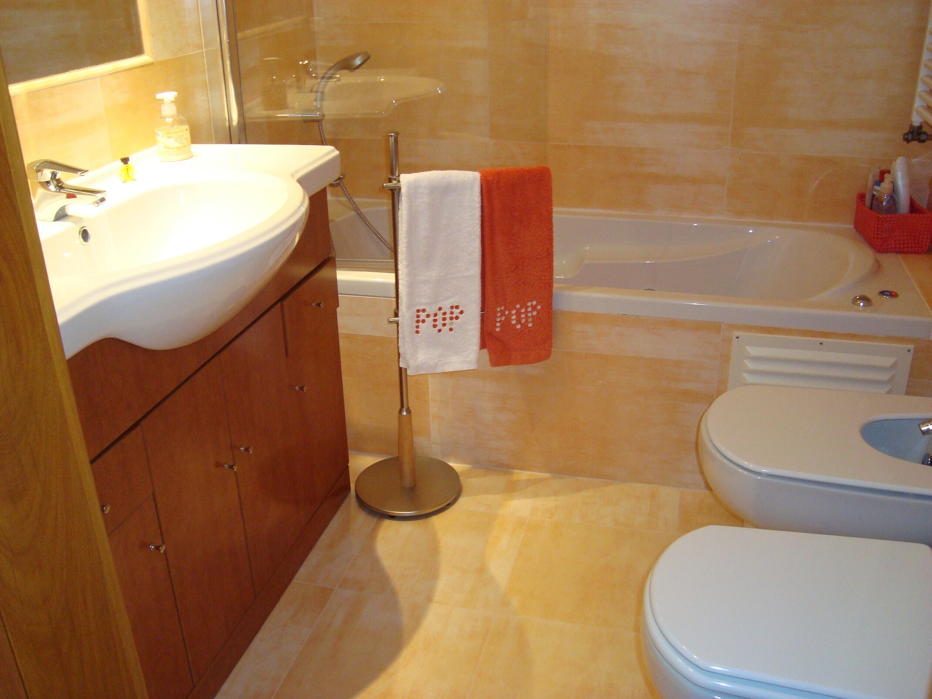 A bathroom with a sink, toilet, and bathtub.