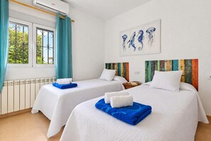 A hotel room with two beds, a radiator, a window with curtains, and artwork on the wall. - Classic and comfortable villa  with private pool in Javea, on the Costa Blanca, Spain for 4 persons (Javea)