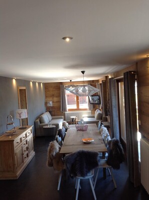 A cozy dining area with a wooden table, chairs, and a dog. - Apartment/ flat - Chatel (Châtel)