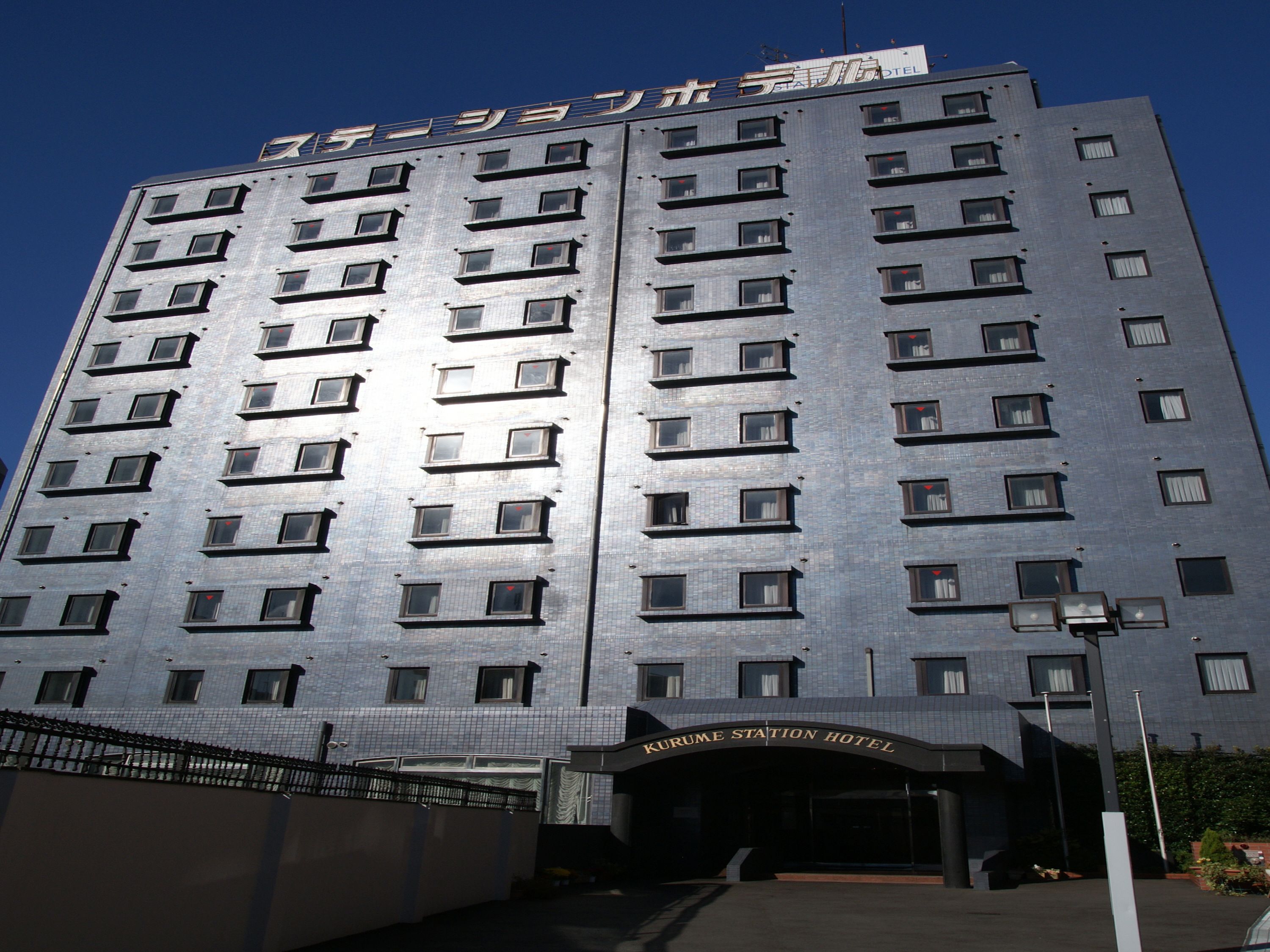 A modern hotel building with a prominent entrance and multiple floors.