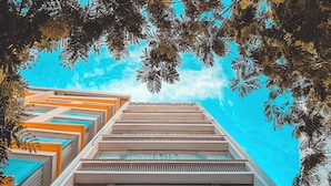 A hotel with a modern design, featuring a prominent sign at the bottom. - The Shann Hotel Da Nang (Da Nang)