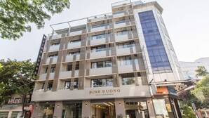 A multi-story hotel with a modern facade, featuring balconies and large windows. - Binh Duong Resident Hotel (Da Nang)