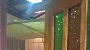 A wooden door with green glass panels and a keyhole. - Jungle house (Unawatuna)
