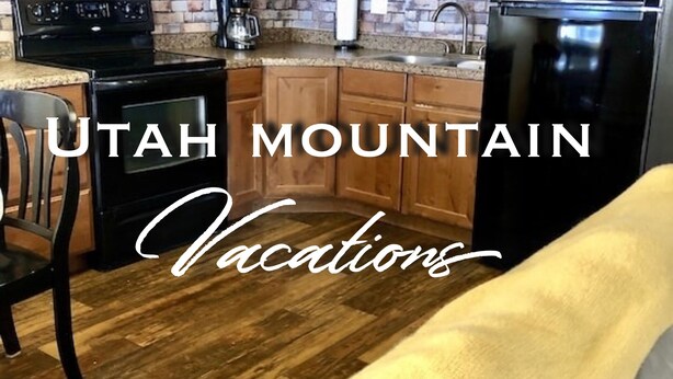 A kitchen with wooden cabinets, a microwave, stove, and refrigerator.