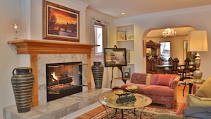 A living room with a fireplace, a sofa, a coffee table, and a chandelier. - . Best in Denver (Denver)