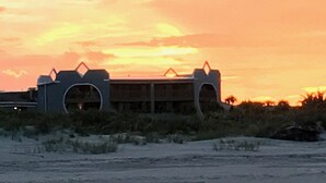 A building with a unique architectural design, featuring a curved roof and multiple arches. - Oceanfront - 3 Bedroom Renovated 1,800 sq ft. + Huge Balcony -  Casual Elegance (St. Augustine Beach)