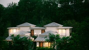 Set amidst lush greenery, this contemporary building offers serene, living with multiple levels and large windows.