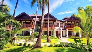 A resort with multiple buildings, each featuring balconies and surrounded by lush greenery and palm trees. - Yoma Cherry Lodge (Ngapali)
