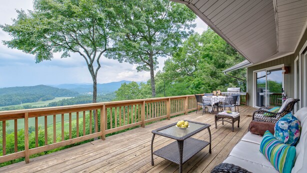 A wooden deck with outdoor furniture, a grill, and a scenic view of hills and trees. - Bella Regalo, Private 2BR, 2BA Mountain Escape, Upgraded with Panoramic Views (Pisgah Forest)