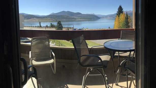 A balcony with a view of a lake and mountains, furnished with chairs and a table. - Amazing Mountain & Lakefront Views- Special!  1 FREE nite w/ 7 nite booking (Dillon)