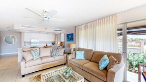 A modern living room with two sofas, a coffee table, and a ceiling fan. - Top Floor, Corner 2 Bedroom, Ocean View, Beach Cabana, 3 pools, Jacuzzi. (Kaanapali)