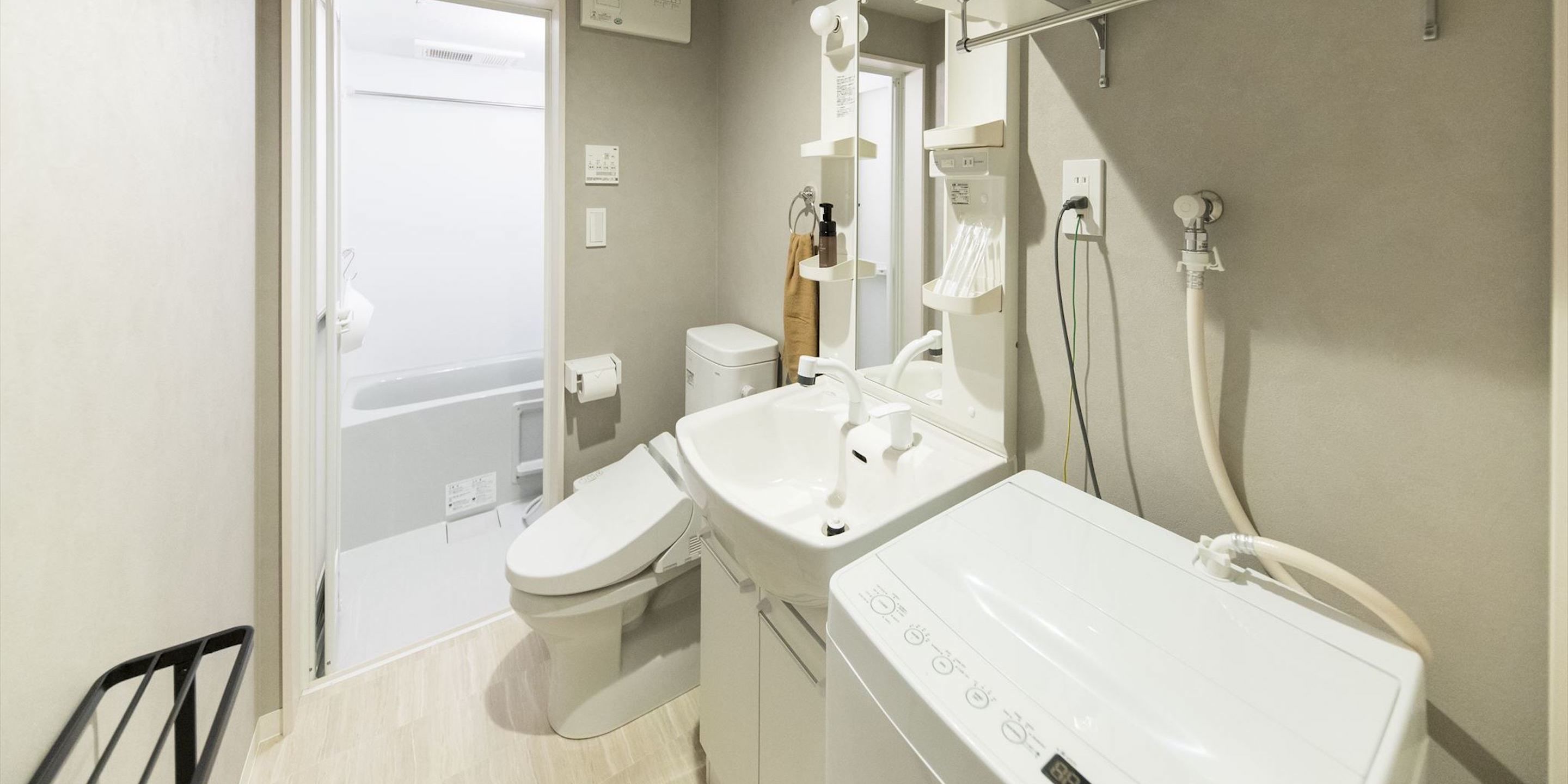A modern bathroom with a toilet, sink, and shower.