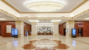 A spacious lobby with a central chandelier, a reception desk, and digital information kiosks. - Dalian Bangchui Island Hotel (Dalian)