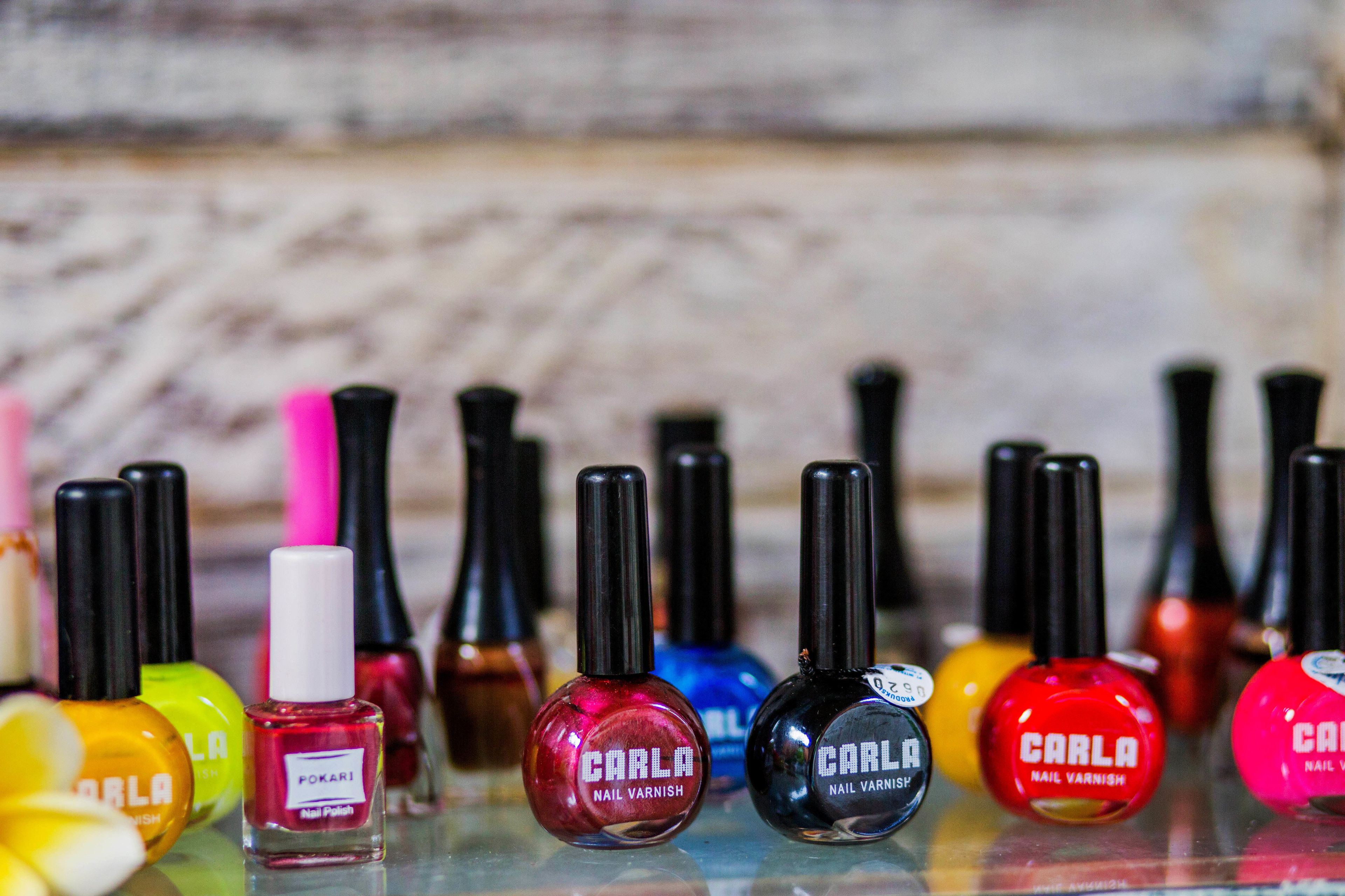 A variety of nail polish bottles arranged on a surface.