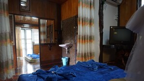 A bedroom with a bed, a sink, a television, and a window with curtains. - Rai Aeifoon Resort (Thep Sathit)