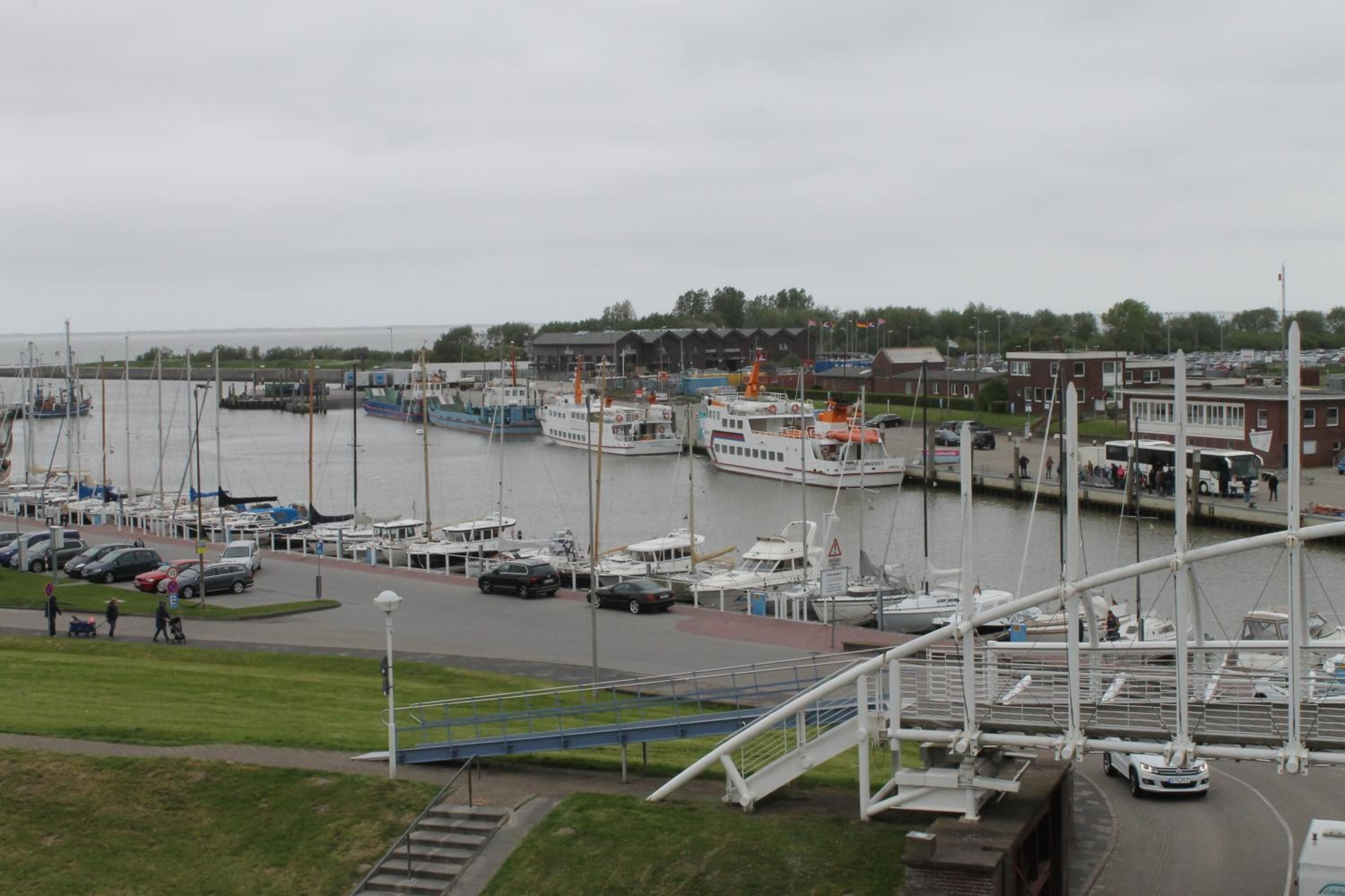 A marina with boats docked and a pedestrian walkway.