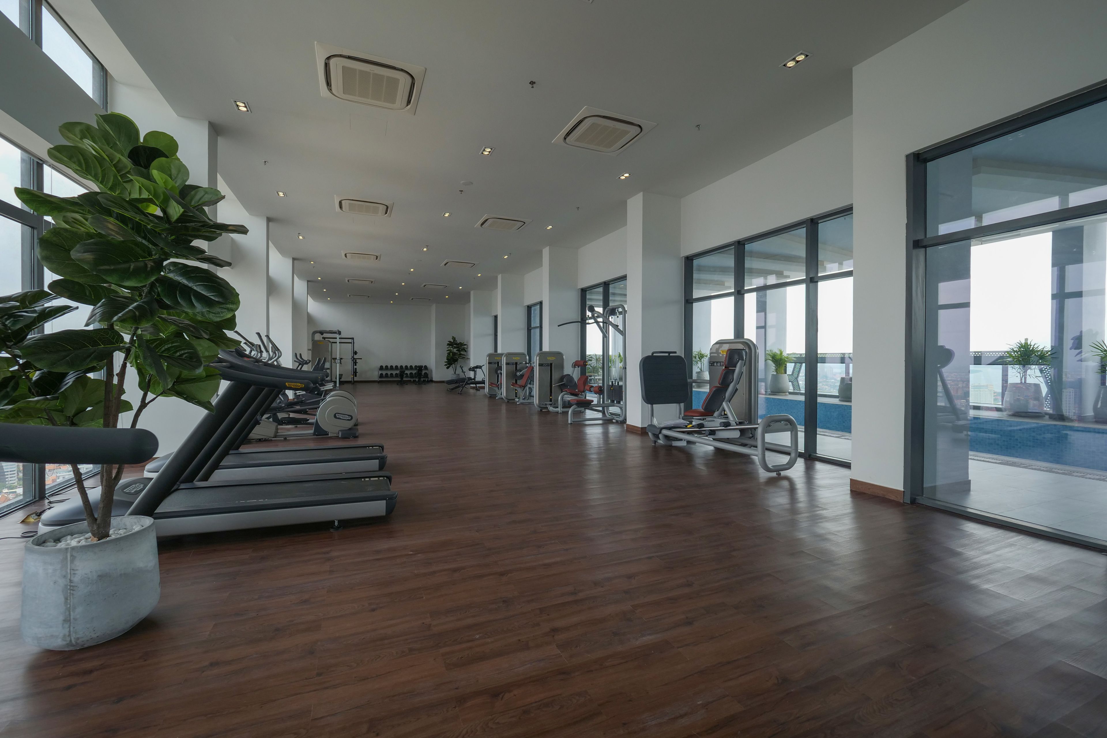 A spacious gym with treadmills, stationary bikes, and weight machines.