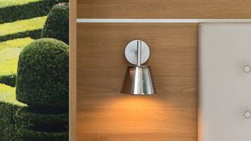 A wooden panel with a wall-mounted light fixture and a cushioned panel.