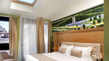 A hotel room with a large bed, a skylight, a mural of a garden, and a view of buildings outside.