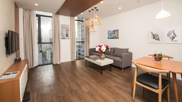 A modern living room with a sofa, coffee table, and dining table.