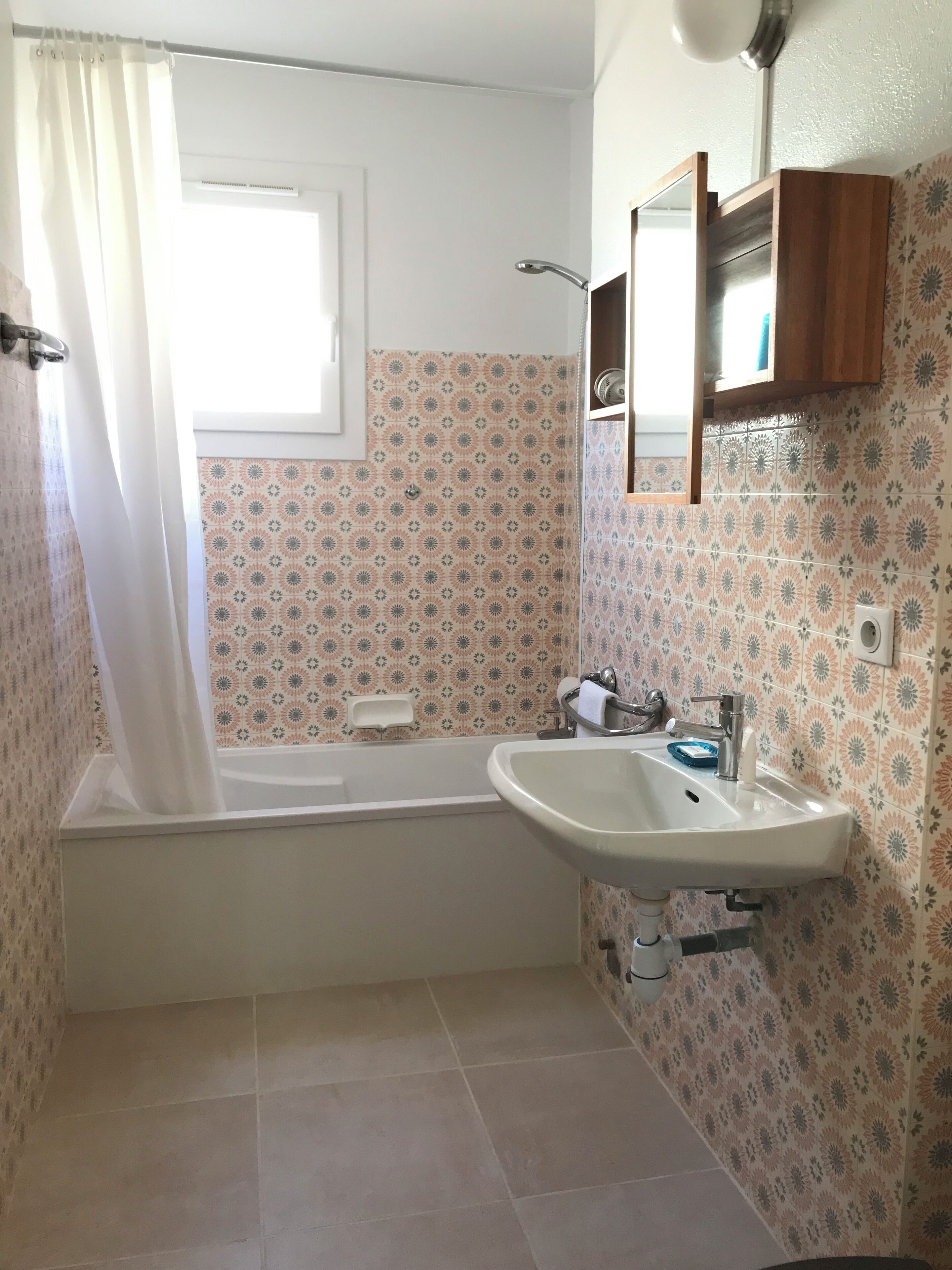 A bathroom with a bathtub, a sink, and a shower.