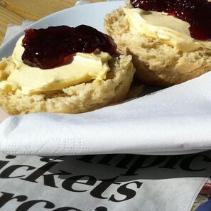 Two scones with jam and cream on a white napkin. - Weirholme Annex (Barnstaple)