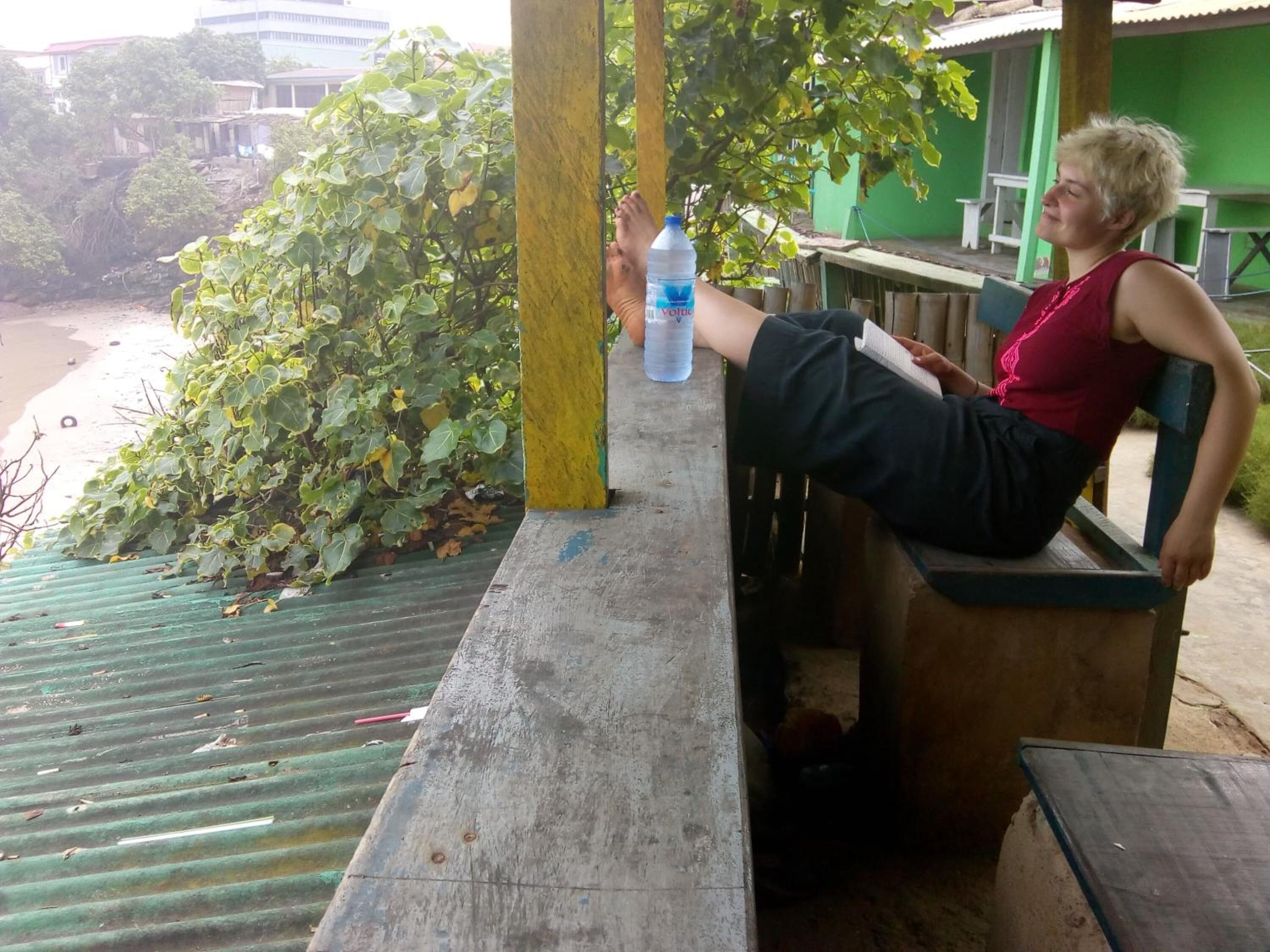 A person sitting on a bench with a water bottle.