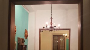 A room with a fish tank, a chandelier, and a dining area with chairs and a table. - Hotel Canarco (Viareggio)