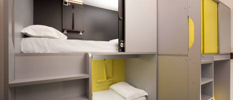A modern, multi-level bedroom with built-in storage and a separate sleeping area.