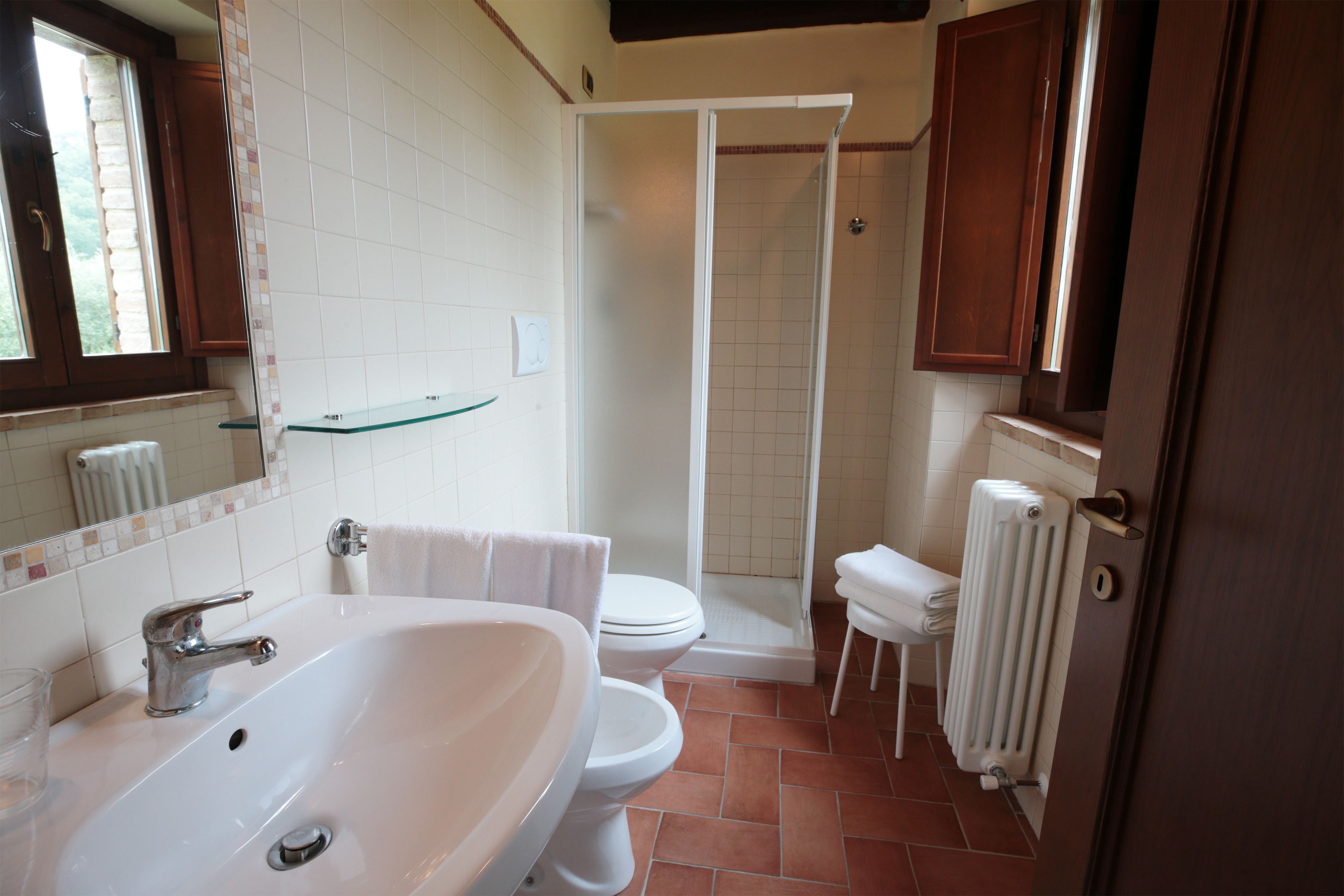 Un baño con lavamanos, inodoro y ducha.
