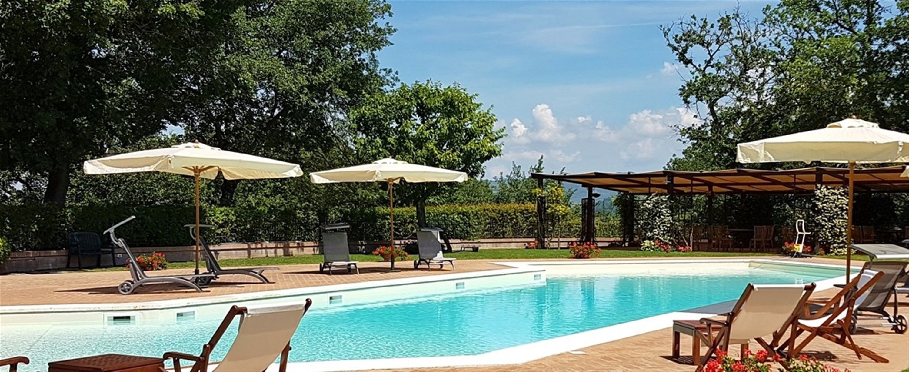 Seasonal outdoor pool, open 10:00 AM to 7:00 PM, pool umbrellas