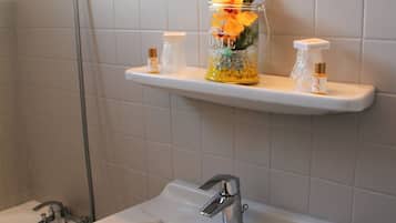 Separate tub and shower, deep soaking tub, free toiletries, towels