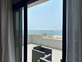 Un balcon avec vue sur la mer et une plage.