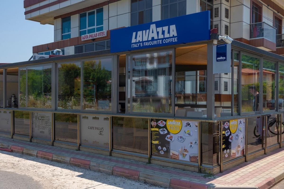 A Lavazza coffee shop with large windows and a sign advertising Italy's favorite coffee.