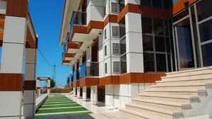 A modern building with a series of balconies and large windows.