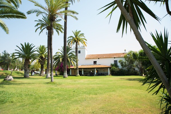 A white building with a tiled roof and a covered patio area.