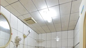 A small bathroom with a sink, toilet, and shower. - YoYo MaAn B&B (Liuqiu)
