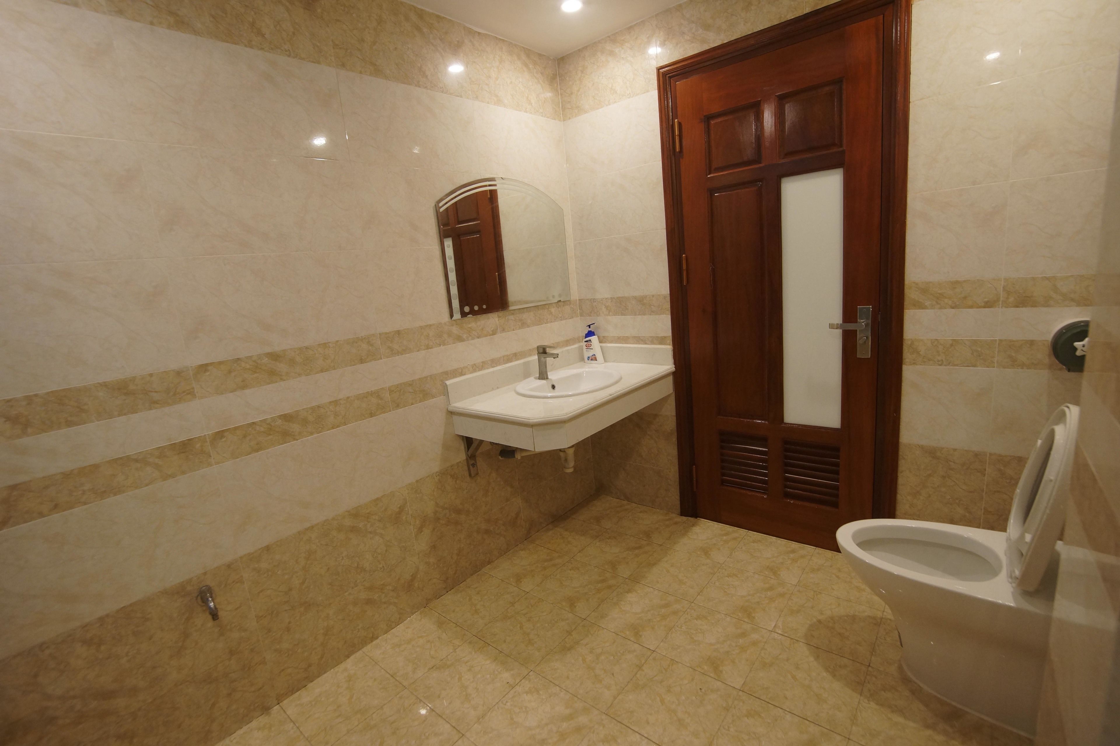 A bathroom with a sink, mirror, and toilet.
