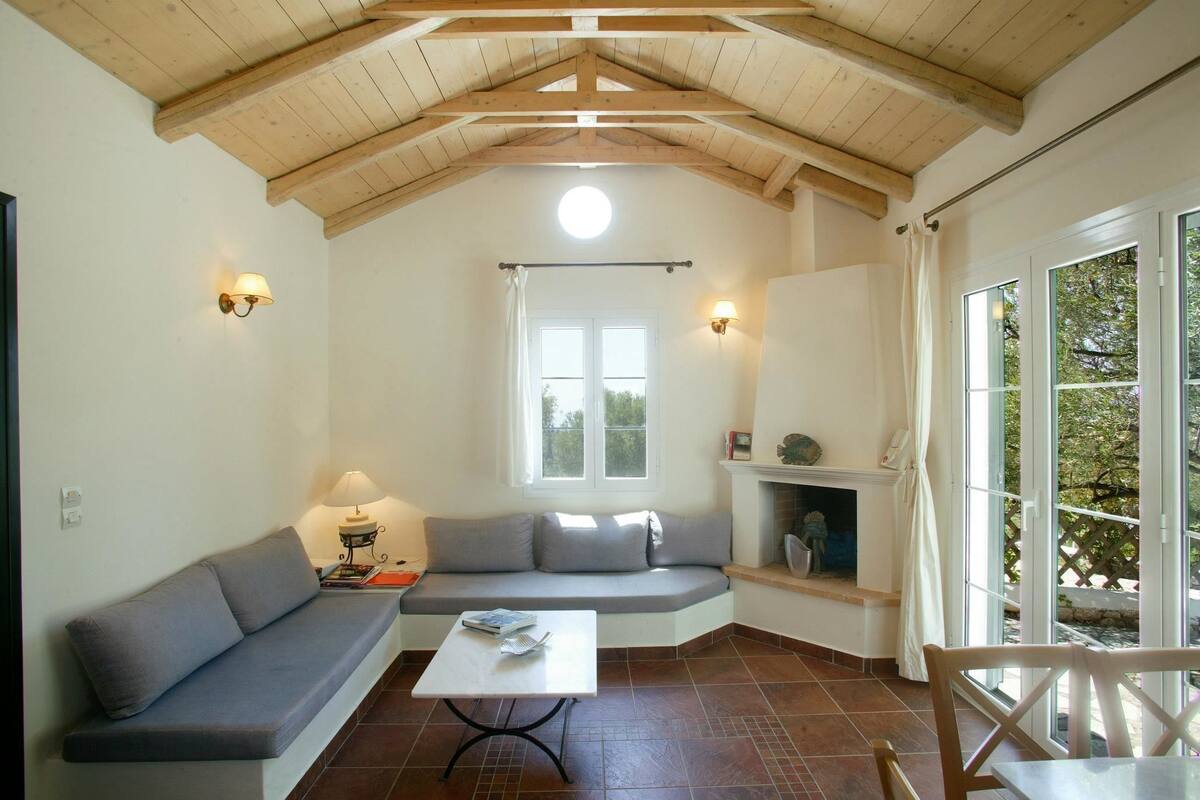 A cozy room with a built-in bench, a table, and a fireplace.