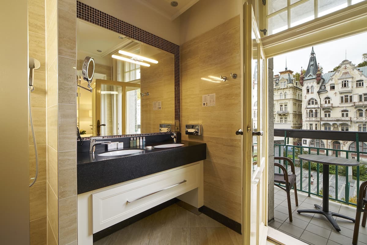 shower, hair dryer, slippers, towels