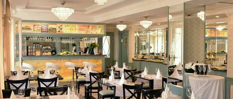 A restaurant with multiple tables set for dining, each with white tablecloths and napkins.