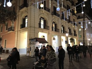 A historic building with arched windows and balconies, decorated with string lights. - B&B Le Marinelle (Salerno)
